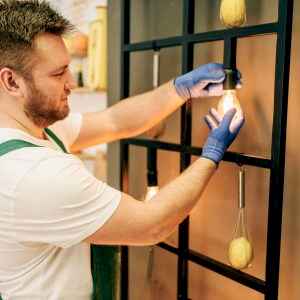 electrician-changes-the-light-bulb-handyman.jpg
